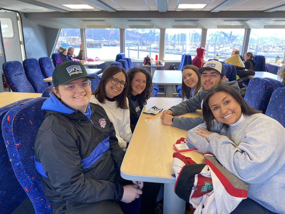 a group of LCU students sitting on a ferry in Resurrection Bay