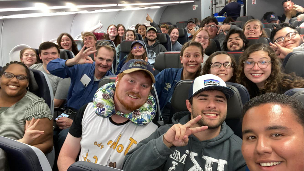 LCU's choir wave to the camera on board a small airplane headed to Alaska