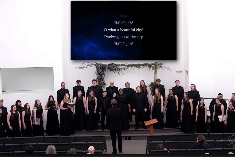 LCU's choir dressed in concert attire giving a performance at a church