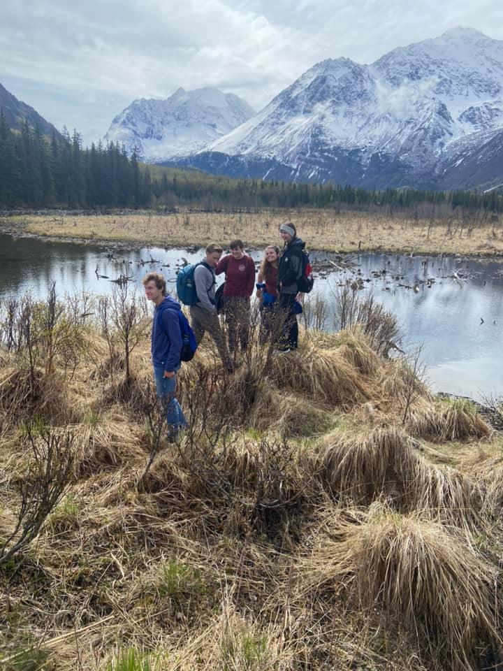 LCU students standing at the foot of large snowcapped mountains in Alaska