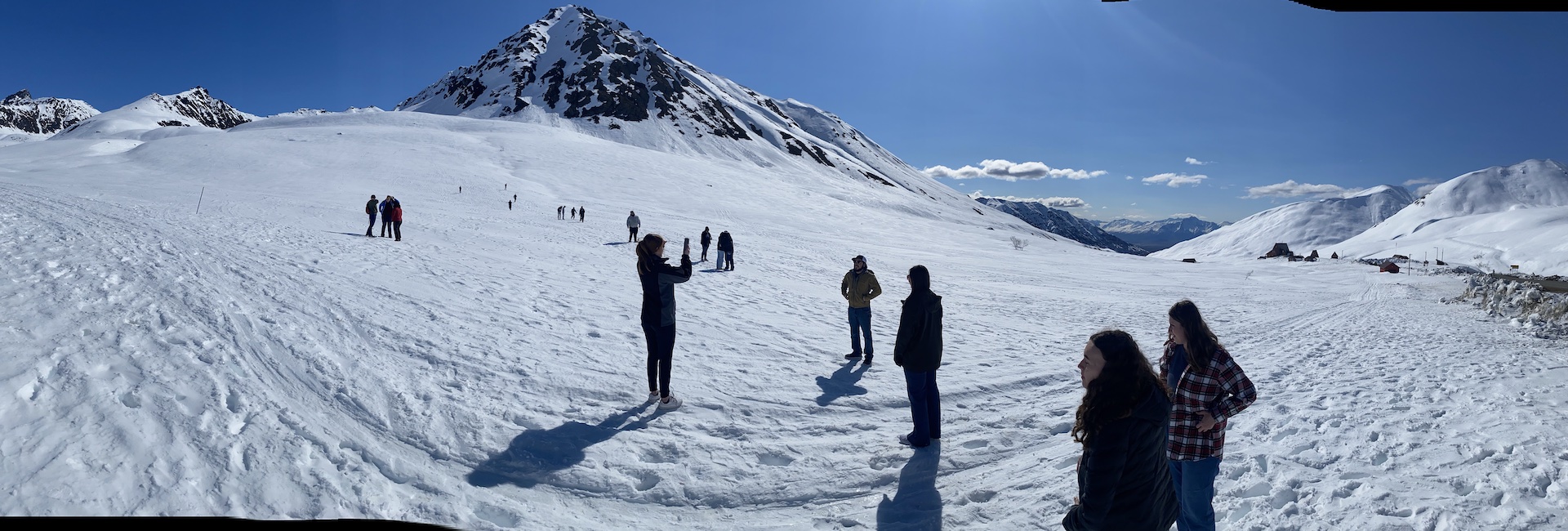 a panoramic view of the choir students exploring a snowy mountainside