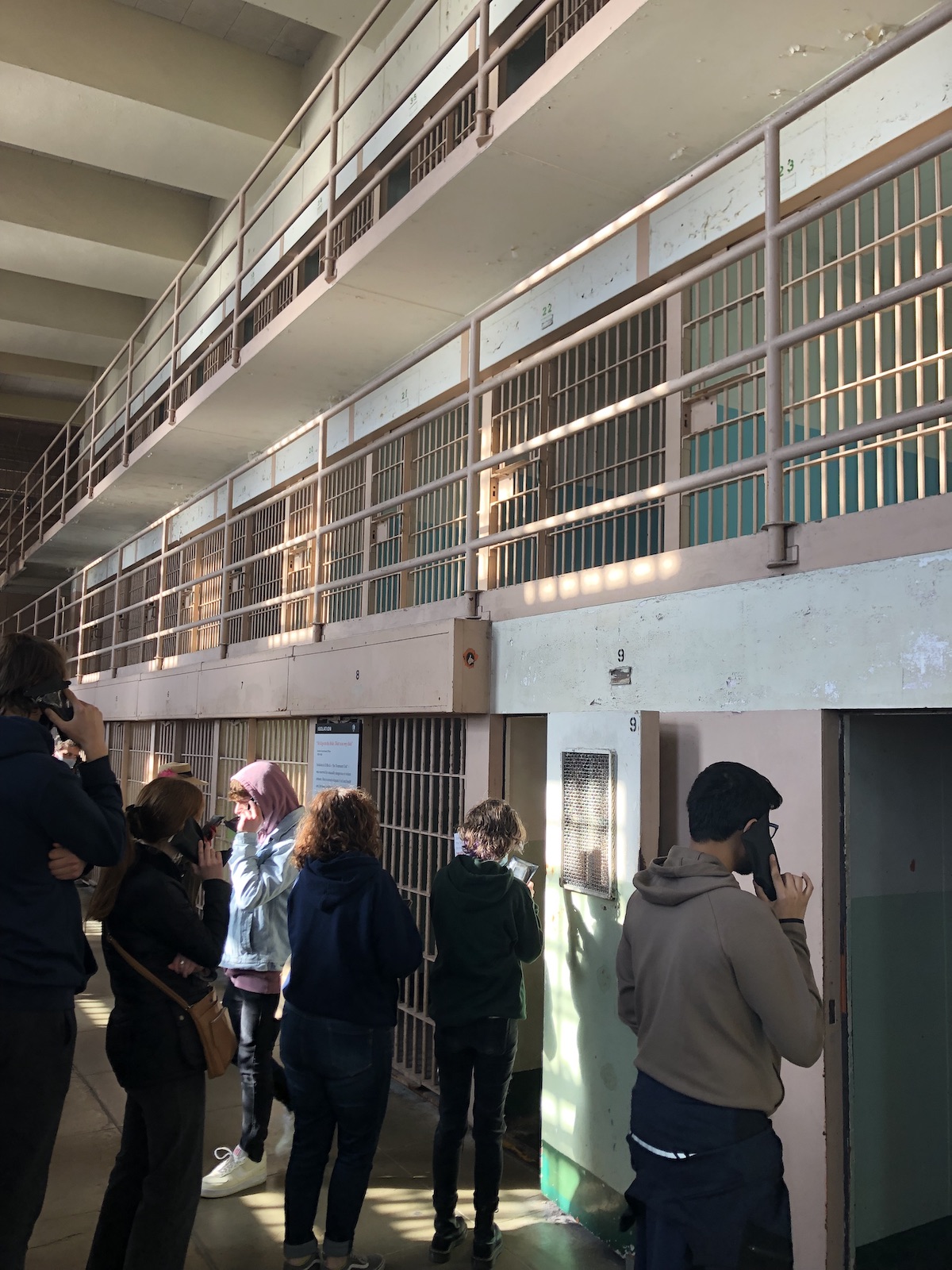 students standing in a maximum security prison listening to historical facts about Alcatraz