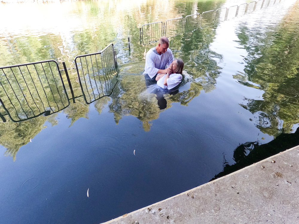Dr. David Fraze baptizes a trip participant in the Jordan River.