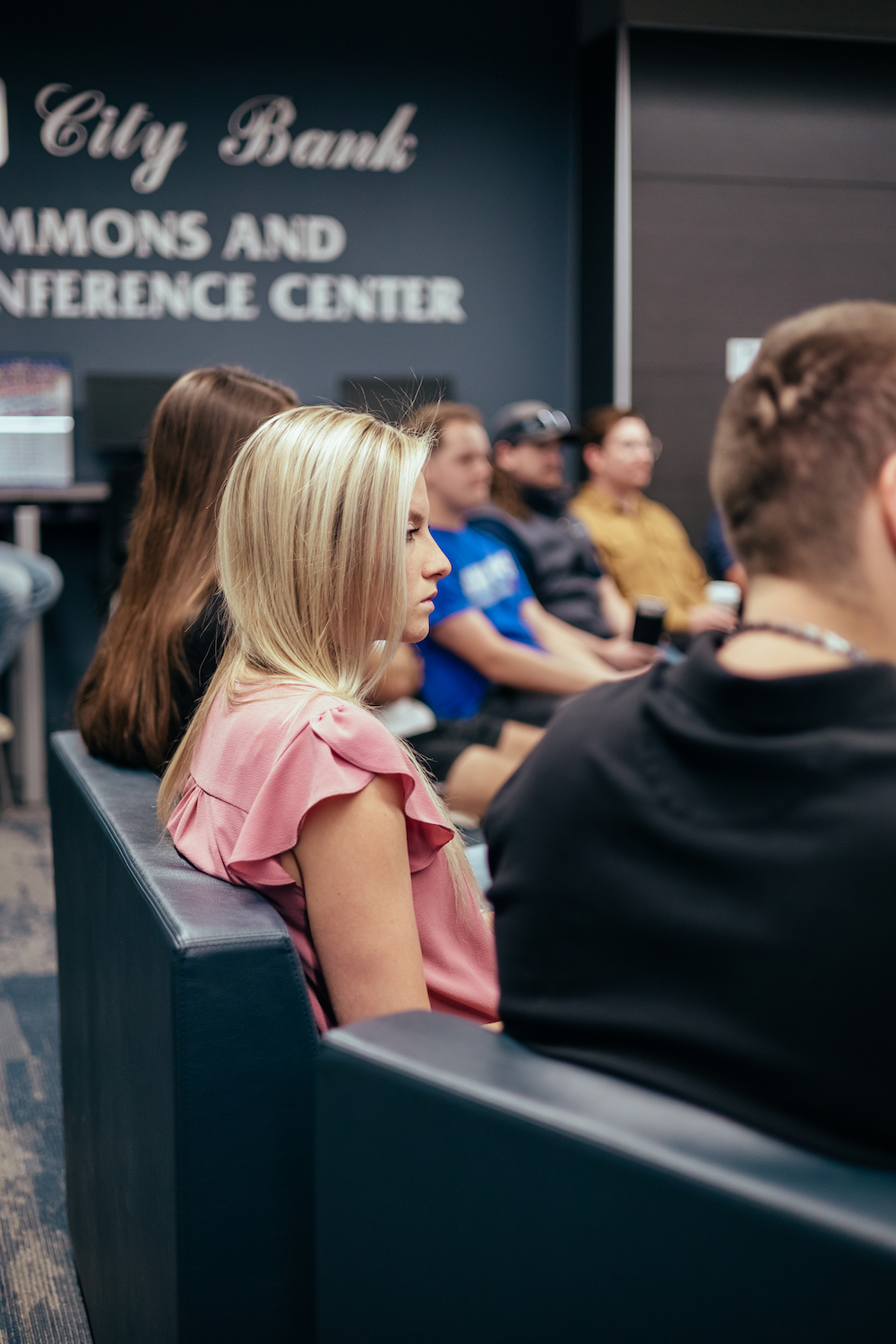 an LCU student sits in on a group discussion in the school of business