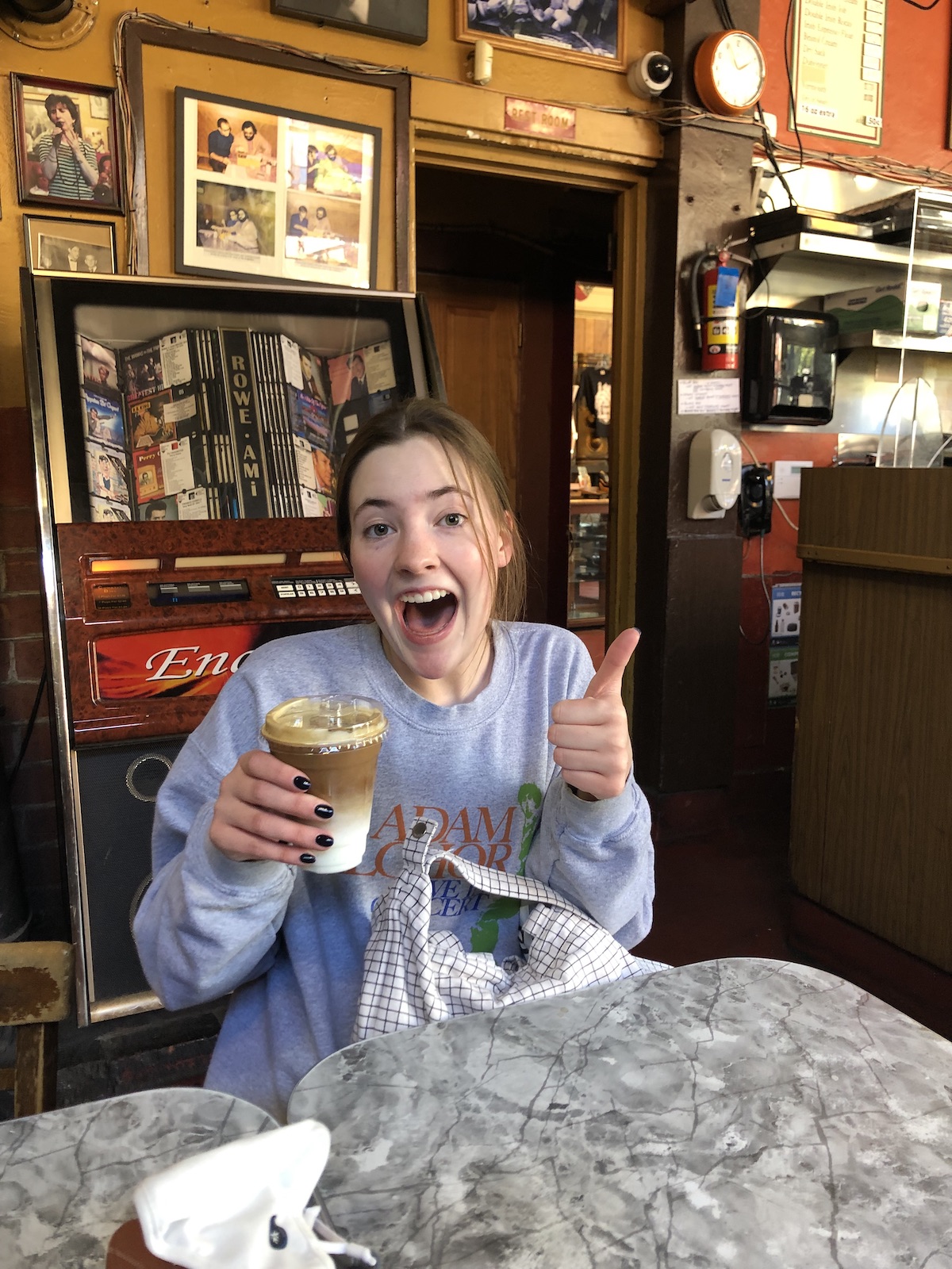 Young woman enjoying an iced drink in Cafe Trieste, where The Godfather was written