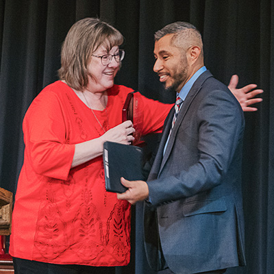 Emmanuel Ramirez being presented an award by Dr. Ronna Privett.