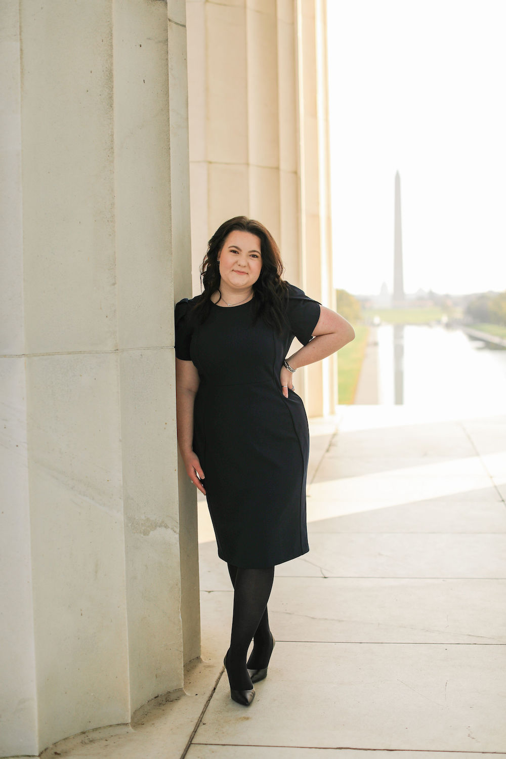 Emma posing next to a large column in Washington D.C.