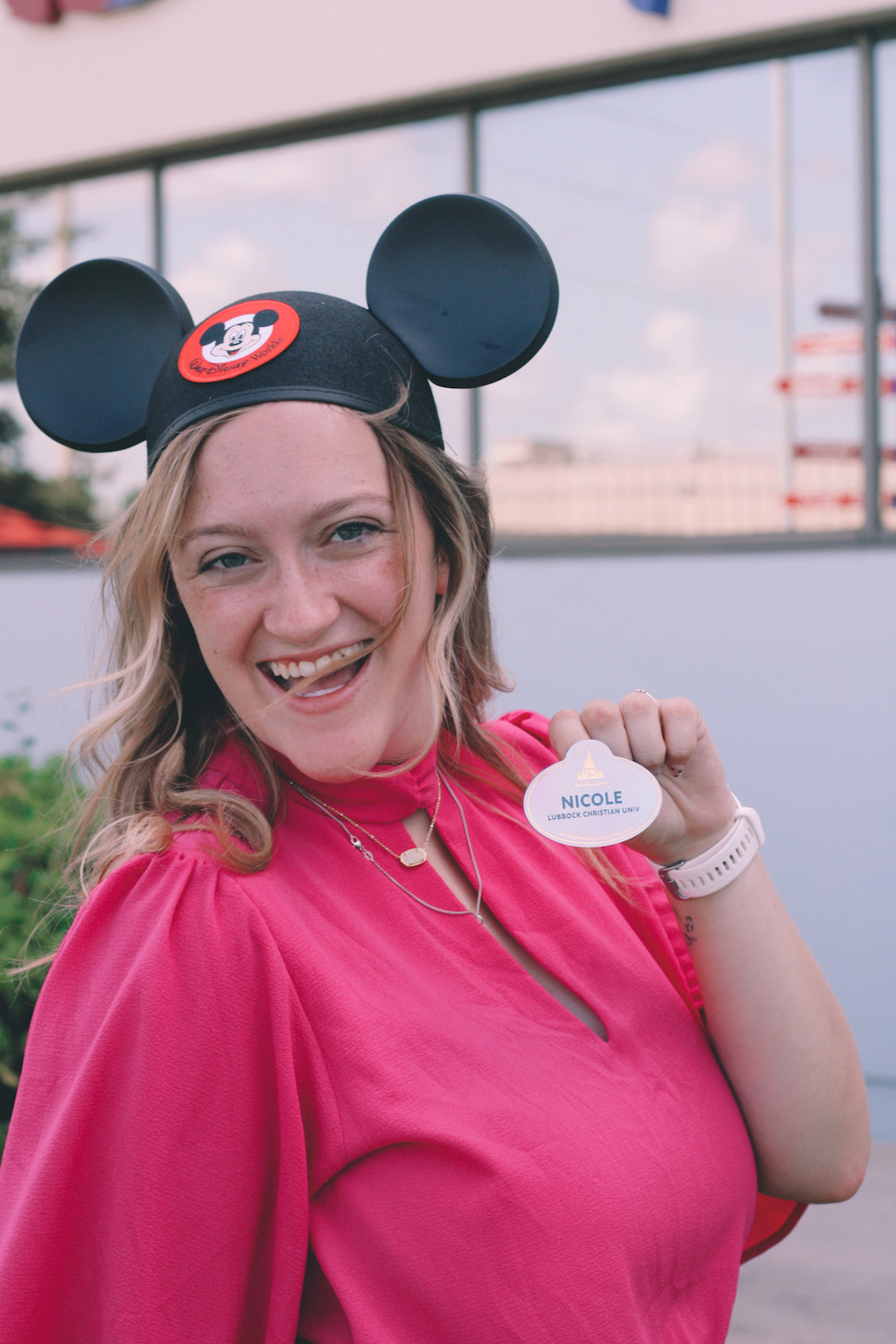 Nicole shows off her Disney badge, which designates her school—Lubbock Christian University