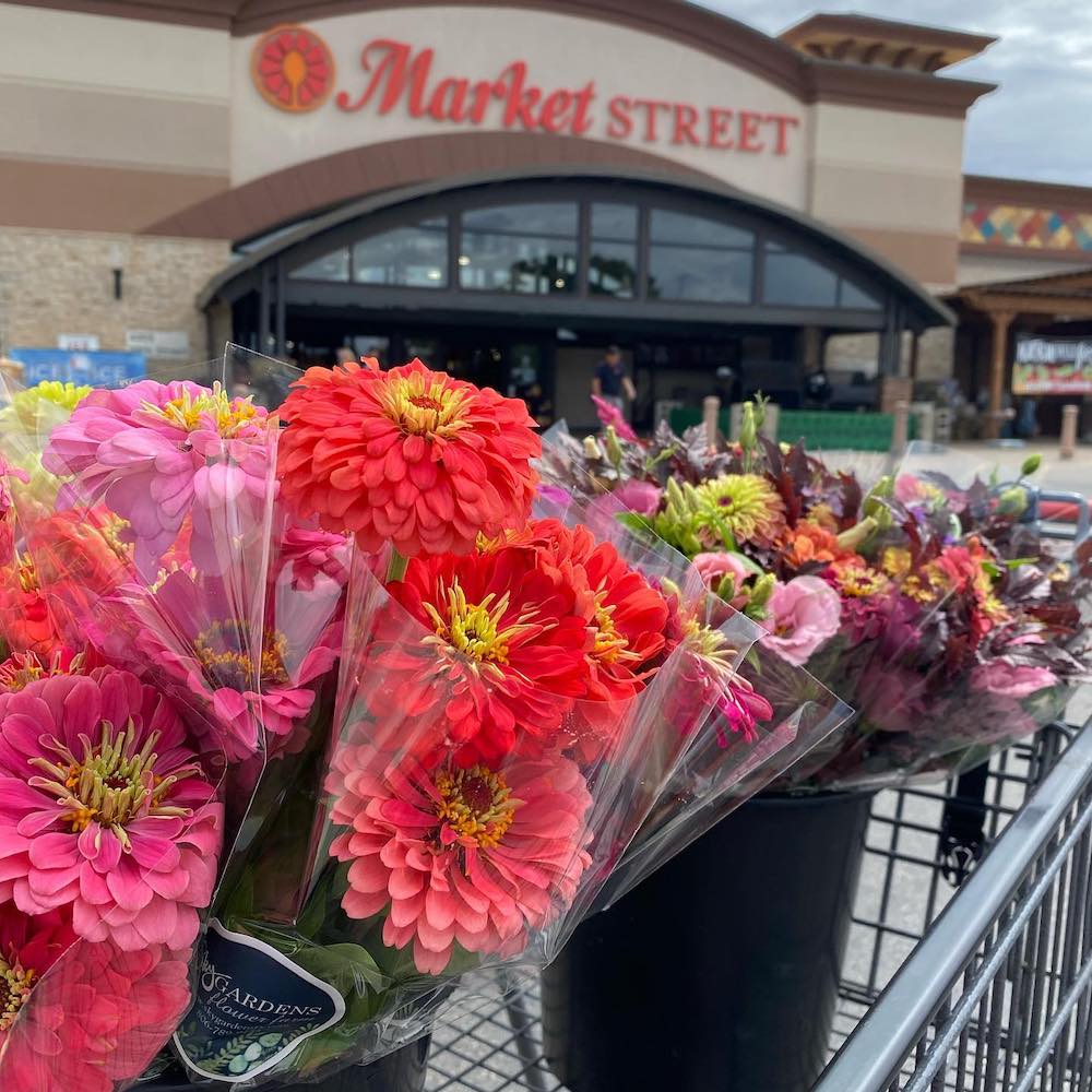 an arrangement of flowers outside of a local Market Street grocery store