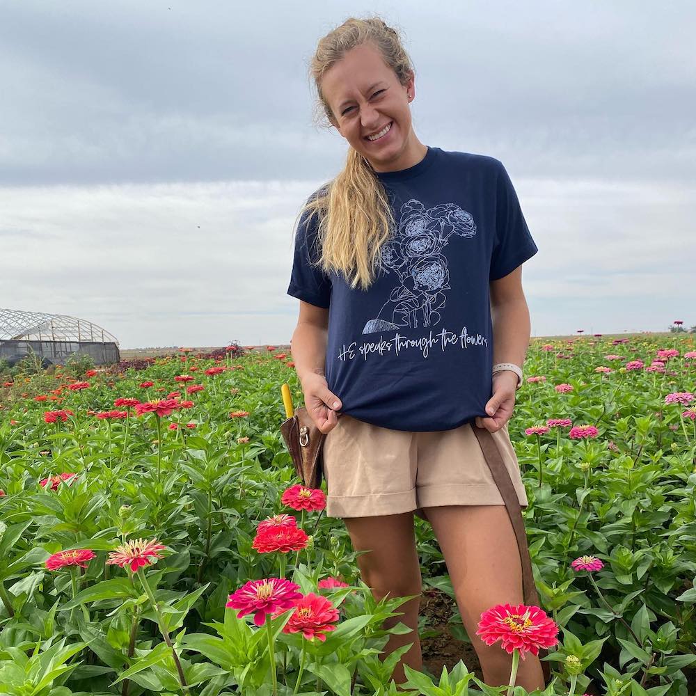 Skyler shows off one of her SkyGardens shirts in her garden