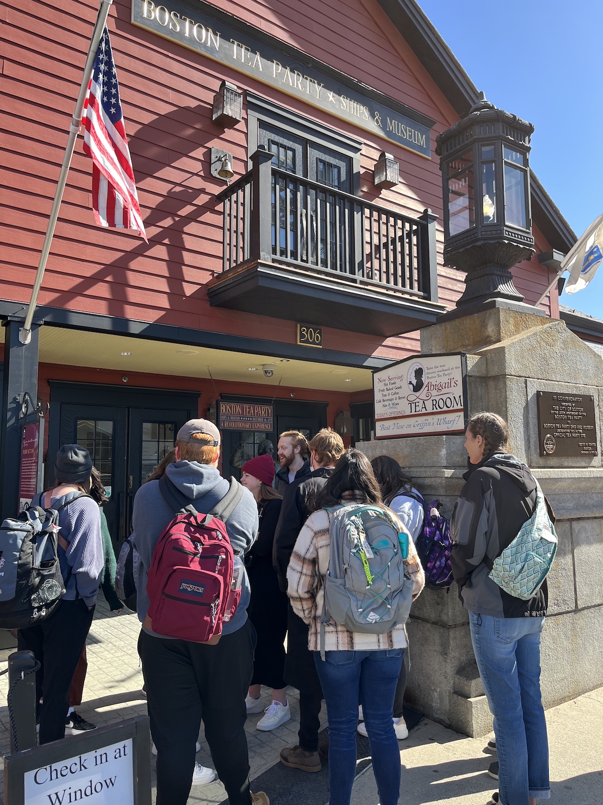 Dr. Fehr's class reading a plaque in front of the Tea Party Museum.