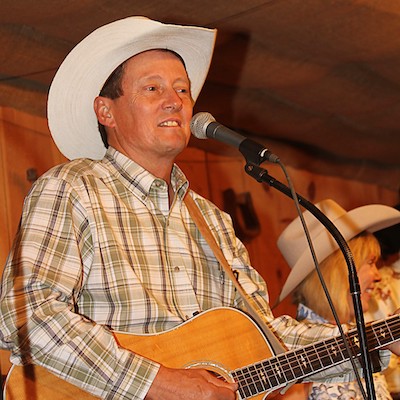 James Hobbs singing with a guitar