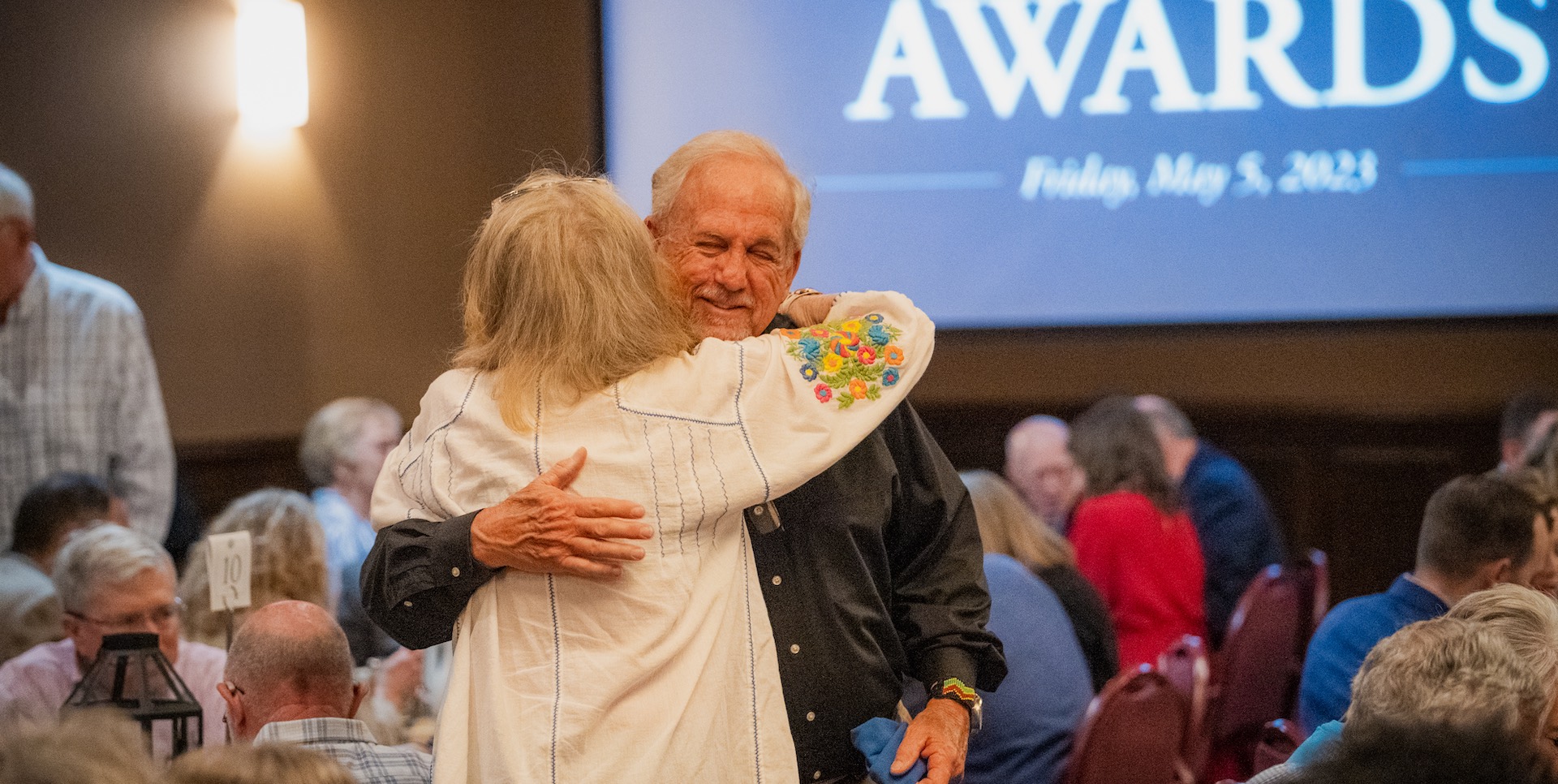 Friends hugging at the awards luncheon