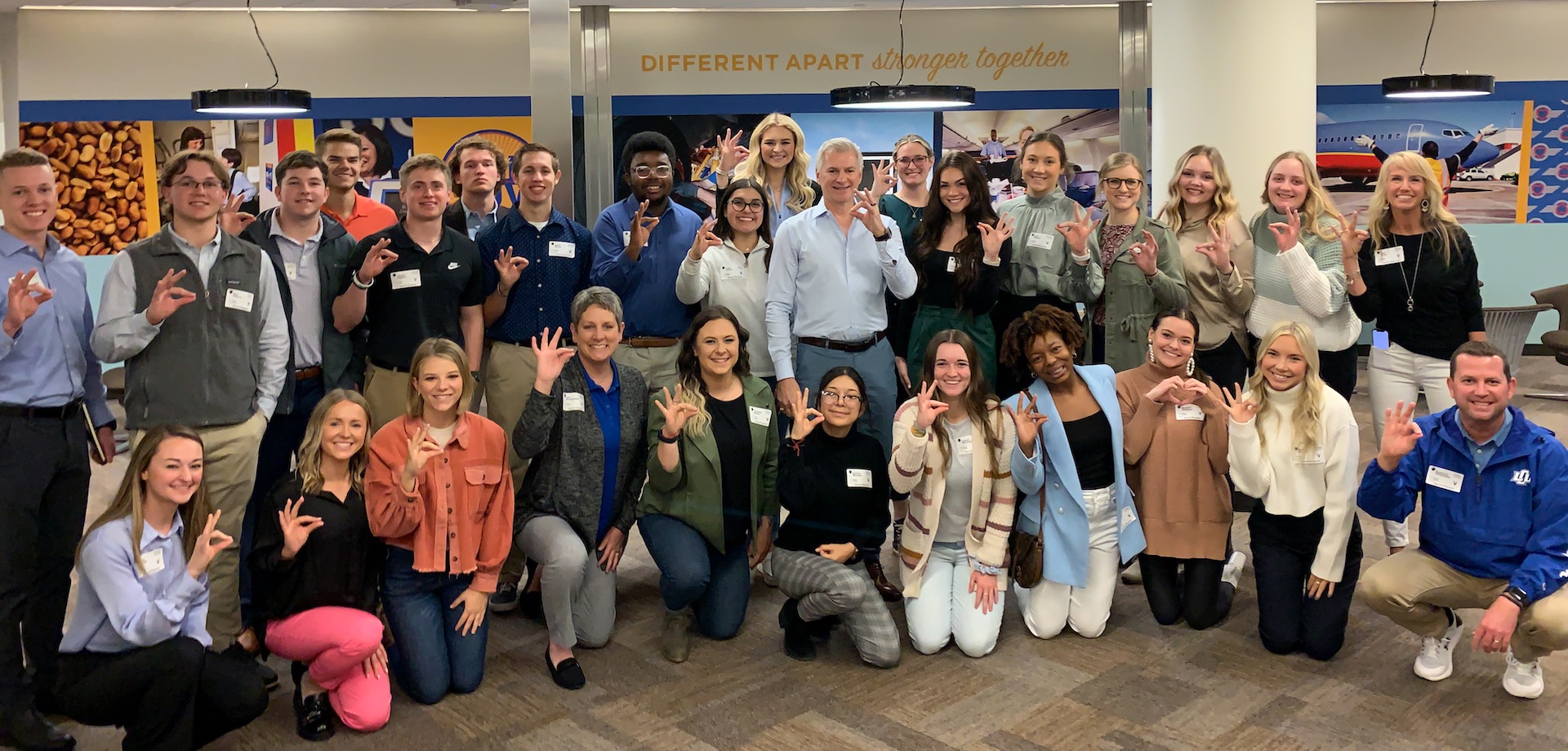 Group of student at Southwest Airlines giving the chap hand sign