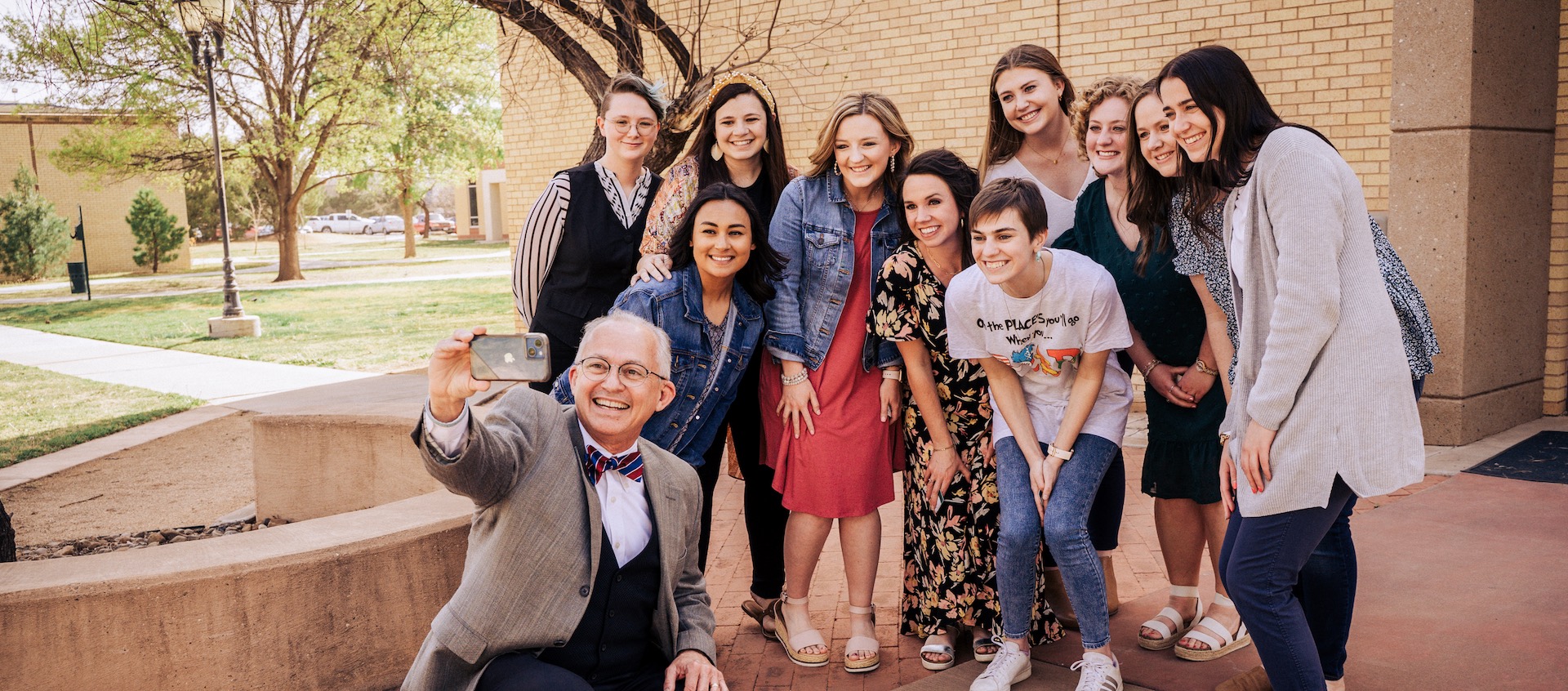 Sam Ayers taking a selfie with students