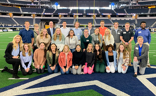 Class of students on the field of the Dallas Cowboys stadium