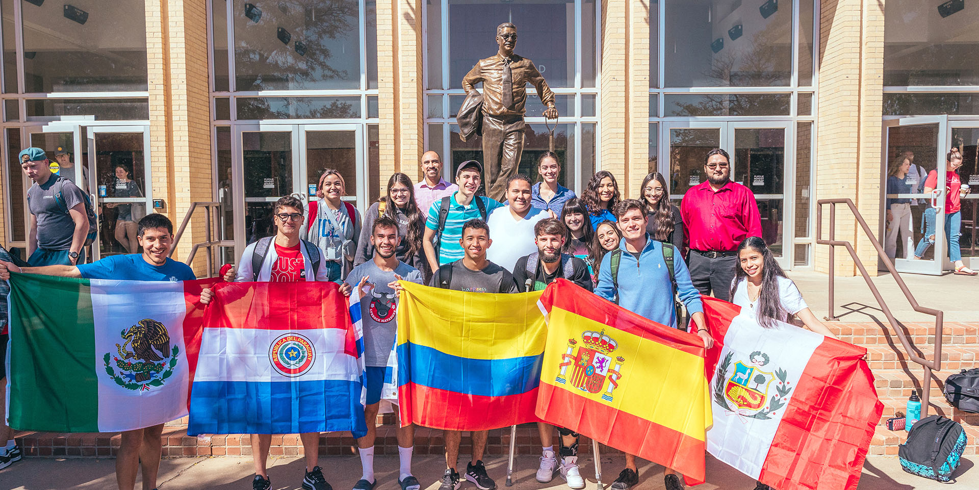 a group of students standing infront of the chap celebrating National Hispanic 