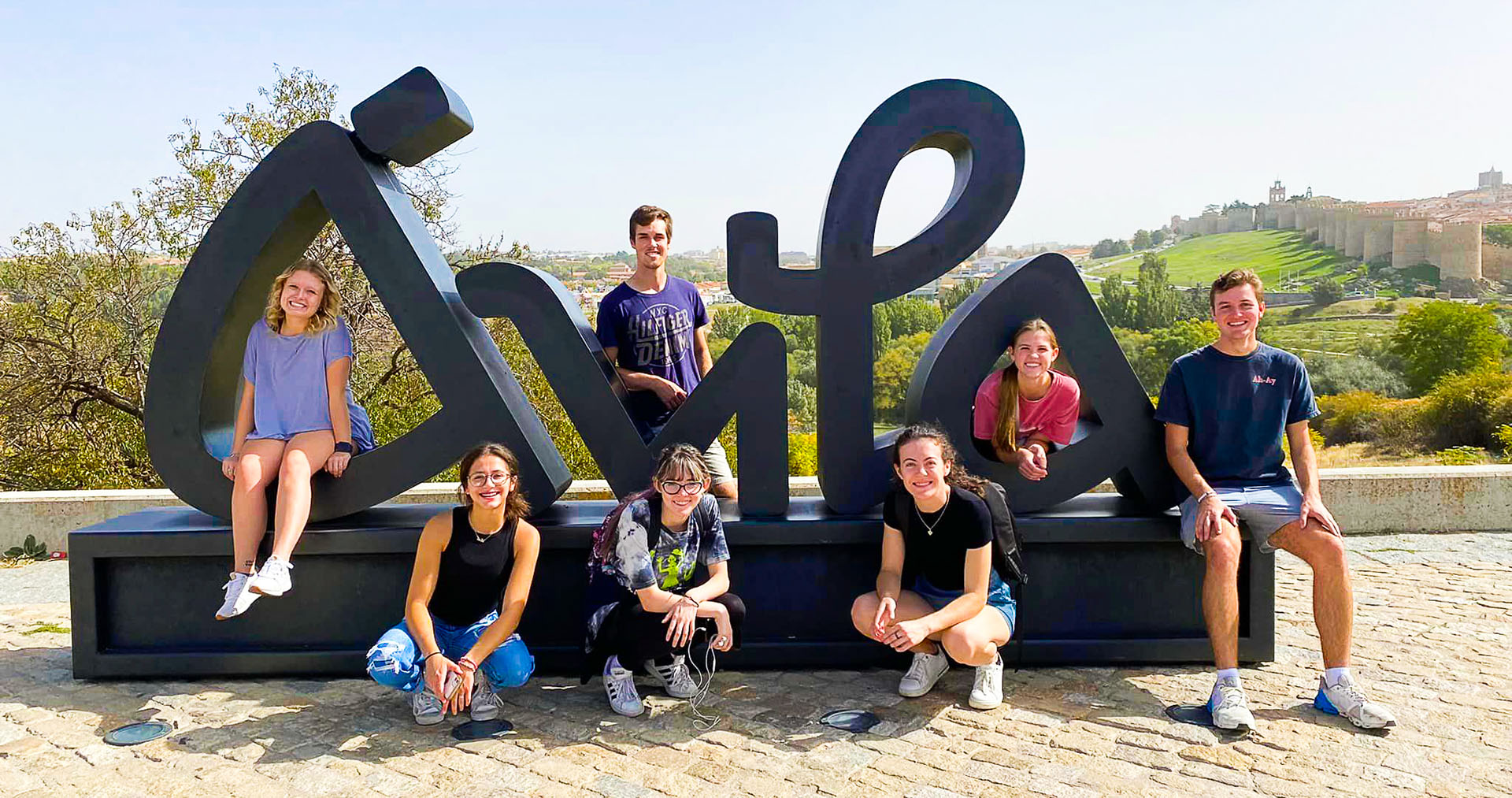 students around a outside sculpture in Avila Spain