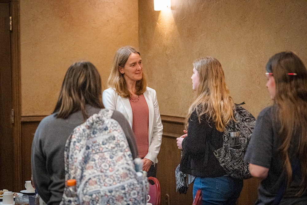Dr. Sharon Dirckx speaks with students at a luncheon.