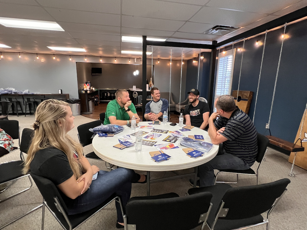 ministers fellowship around a table at an On the Go event