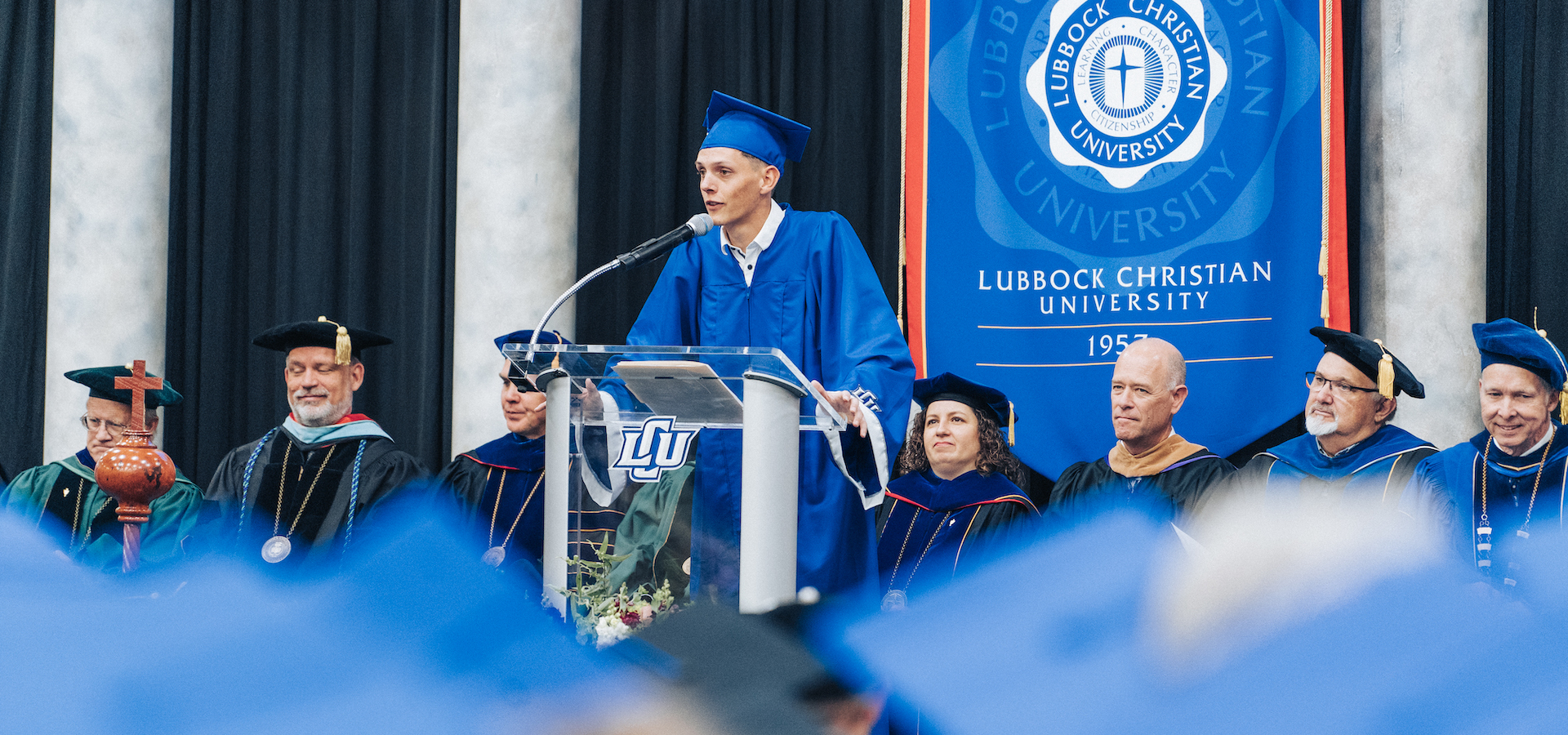 Clem staking on stage at commencement