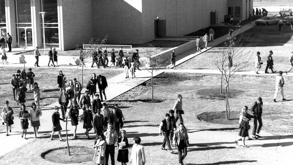 Black and white photograph of students leaving the Moody Auditorium after chapel