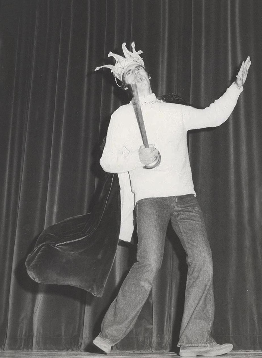 Master Follies host dressed as a jester performing on stage