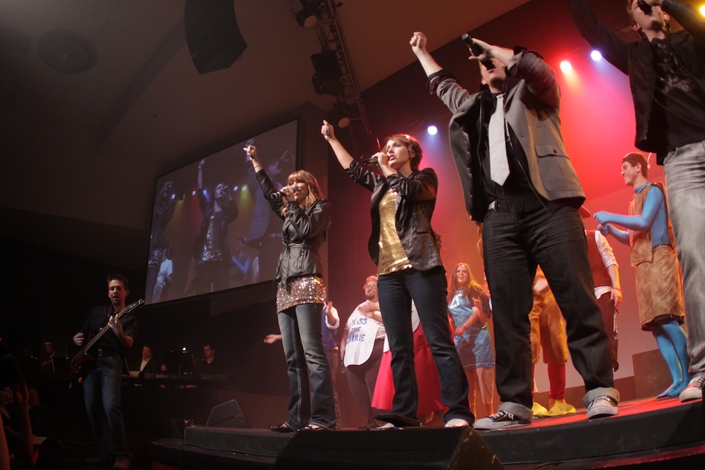 hosts and hostesses from 2012 performing on stage