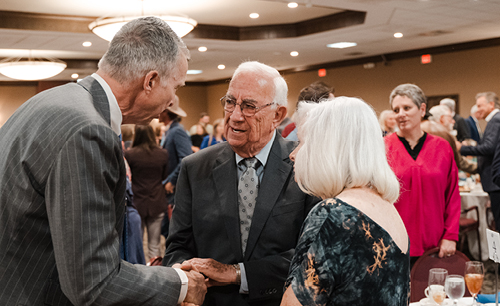 President McDowell talking with an Alumni Awardee in the baker conference center