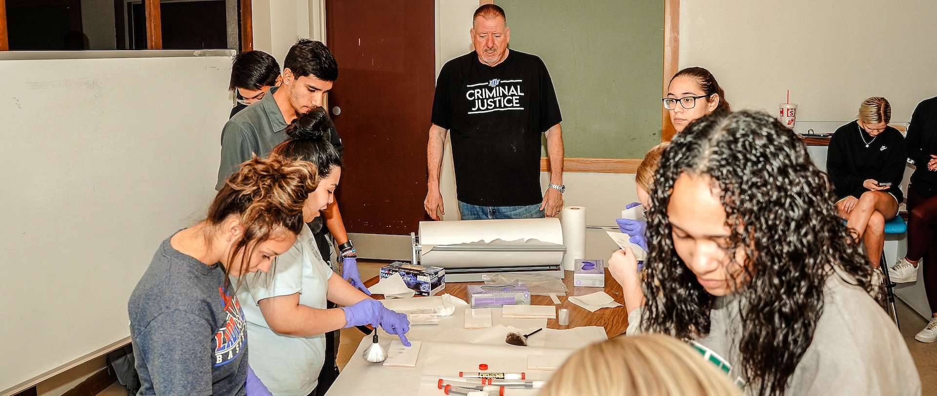 Craig Allen teaching a class in a pretend forensics lab