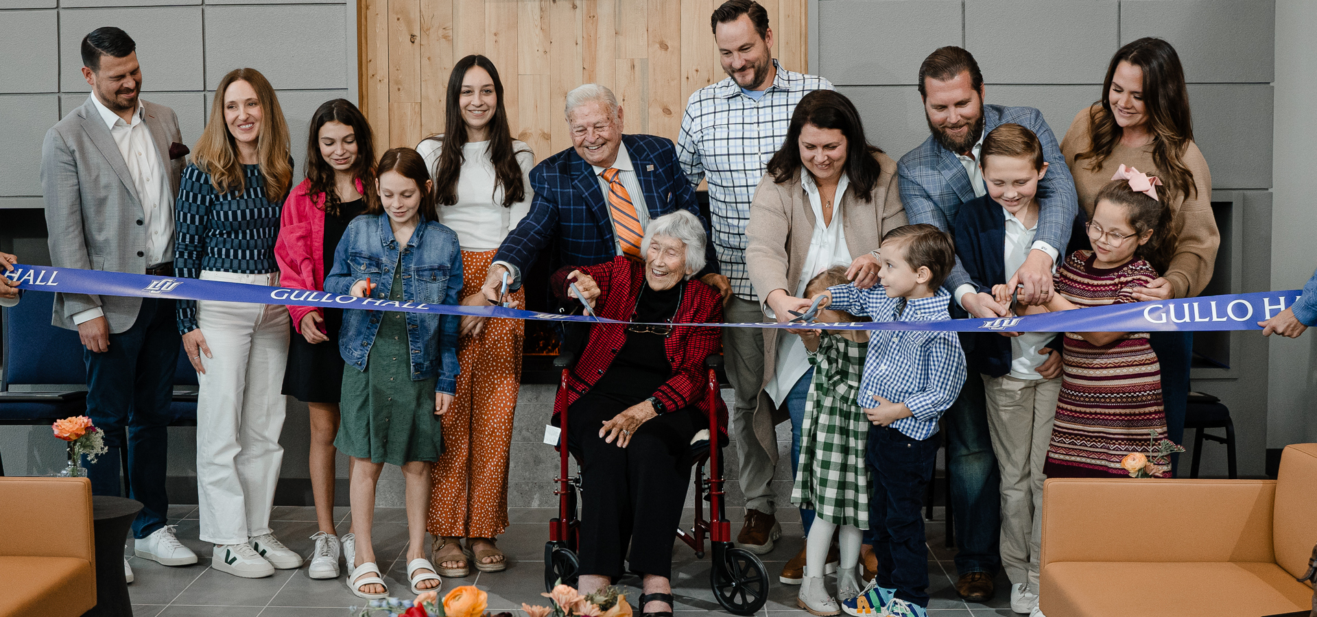 Gullo family cutting the opening ribbon