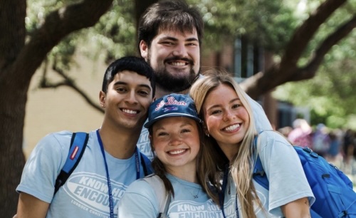 4 camp counselors posing for camera outside