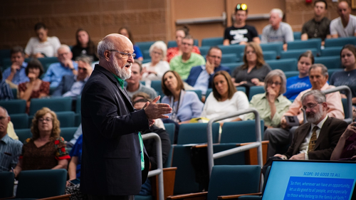 Dr. Darrell Bock talking in front of audience