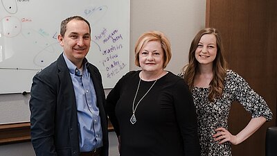 Dr. Fisher, Dr. Marshall and Dr. Fisher standing in a group facing the camera
