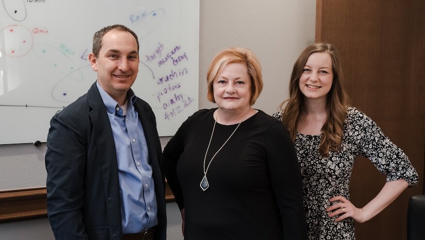 Dr. Fisher, Dr. Marshall and Dr. Fisher standing in a group facing the camera