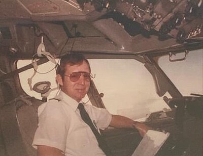 Tom in the cockpit of an airplane