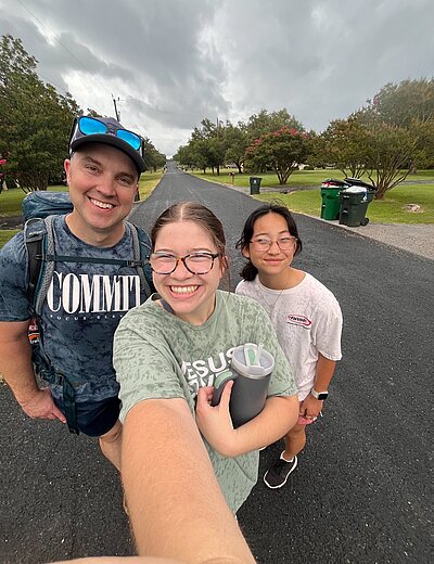 Brooklyn taking a selfie with 2 other on empty residential street