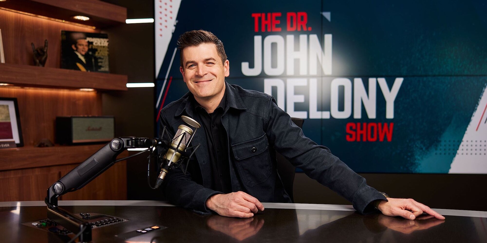 John Delony sitting at his radio desk