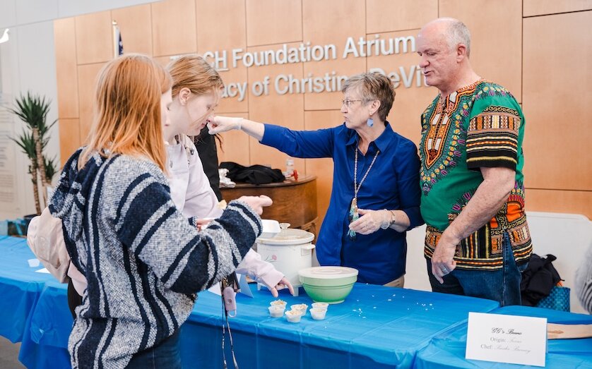 Shawn handing out small tastes to two LCU students
