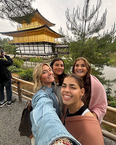 4 LCU students selfing in front of a Japanese building