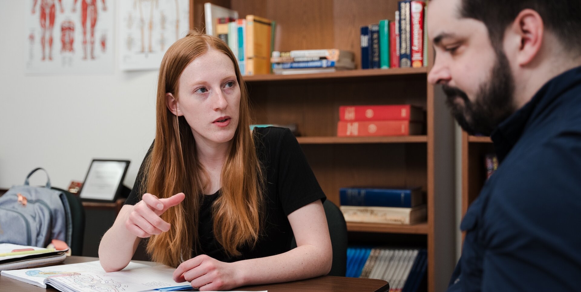 Student getting help understanding a subject at a table with a peer