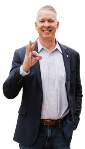 Dr. Scott McDowell standing with the chap sign with his hand