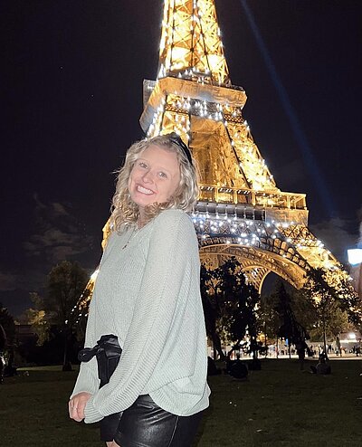 Alexis posing in front of the Eiffel Tower in Paris