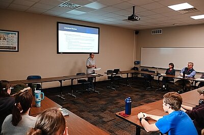 Mia Garza presenting in front a classroom of people