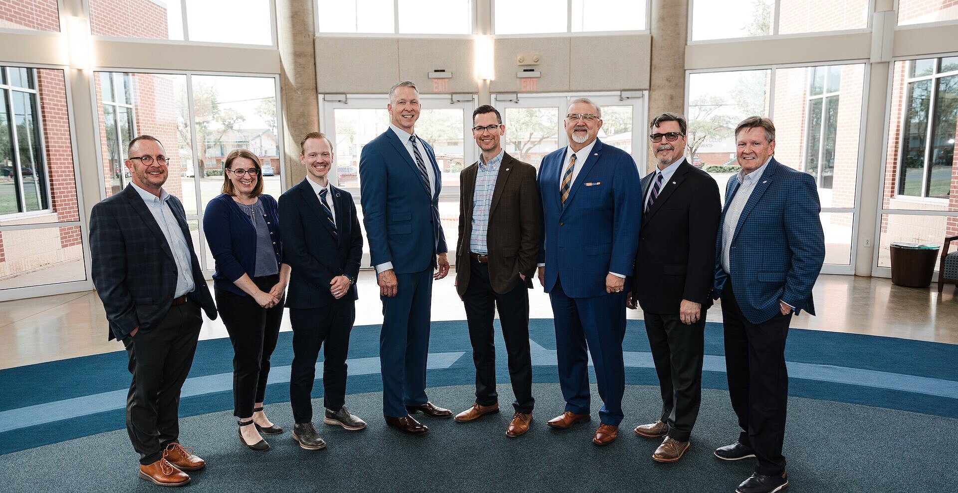 Josh Clem standing in a line with the 6 vice presidents and president