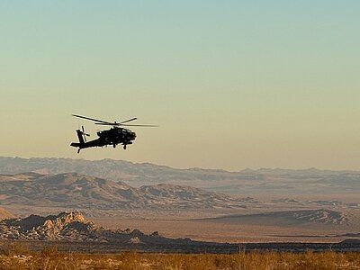 helicopter flying with the backdrop of desert valley
