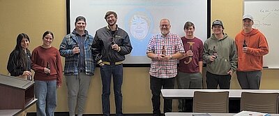 Keith standing with students holding root beers