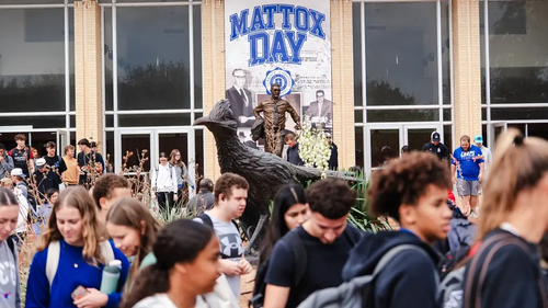 LCU students in front of a large bronze statue of a Chaparral and the statue of F.W. Mattox in the background, in front of a banner with the words "Mattox Day"