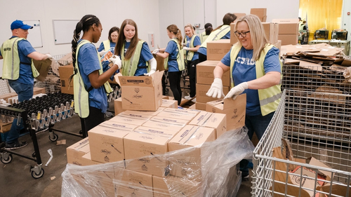 9 lcu staff and students packing food in boxes in a warehouse