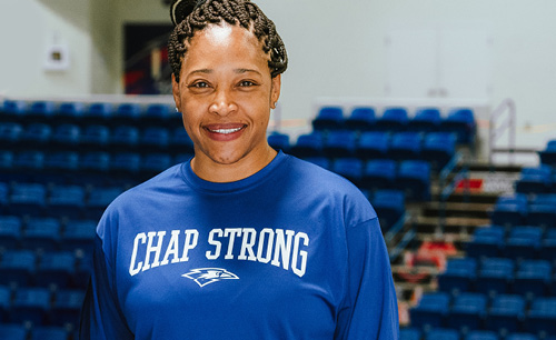 Monica Hill posing in front of empty arena
